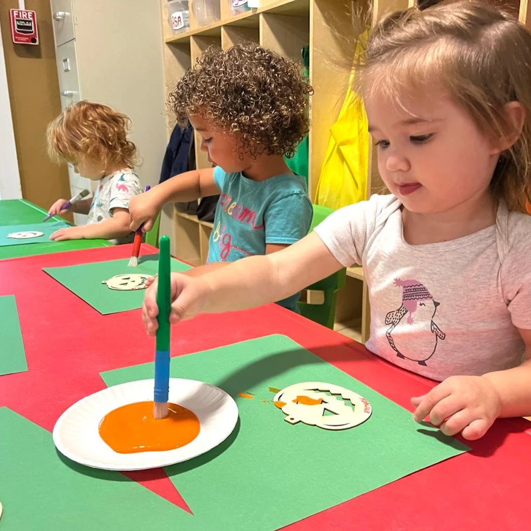 Toddlers engaged in creative play at Busy Bees classroom in Valdosta, GA daycare for 12–24 month olds.