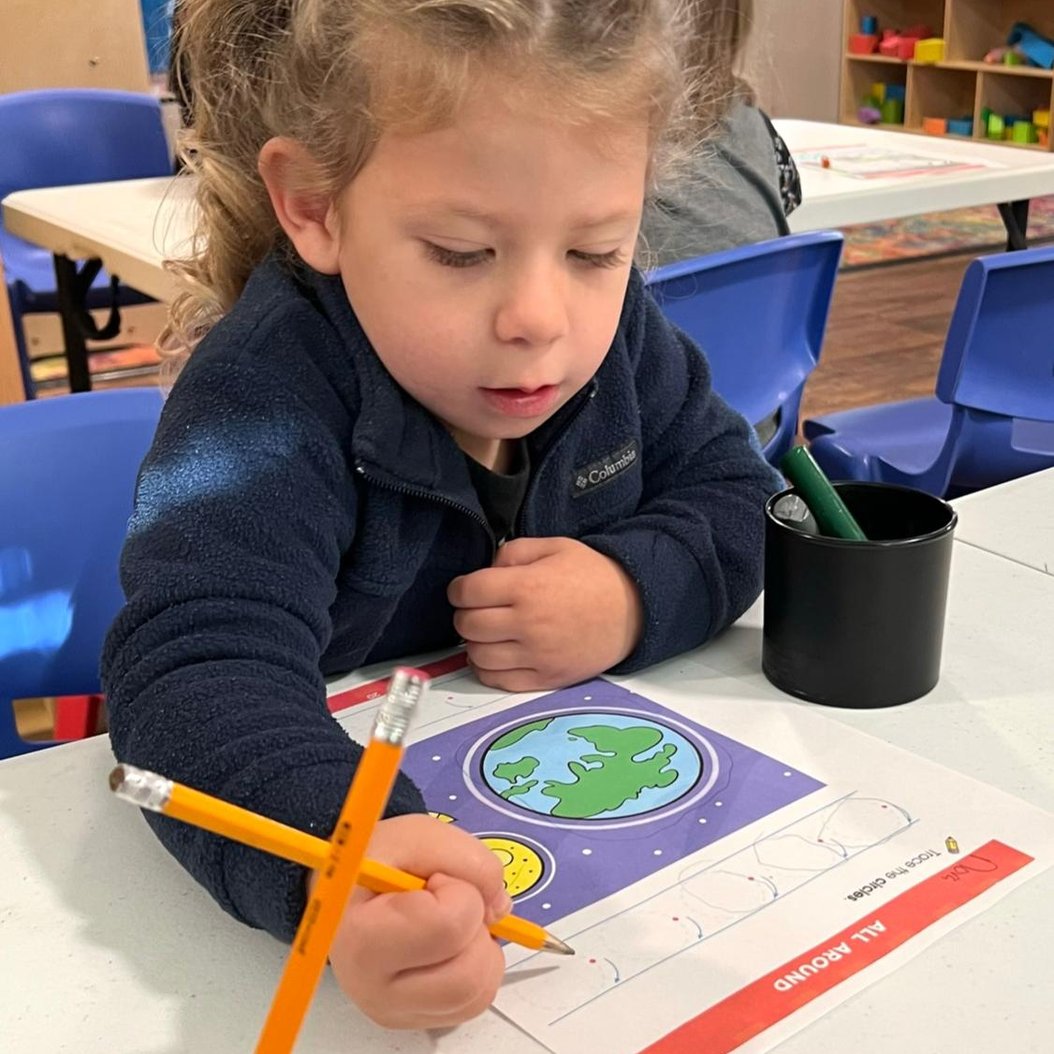 Child engaged in creative activity at Red Trolleys Daycare in Valdosta, GA, fostering growth through play.