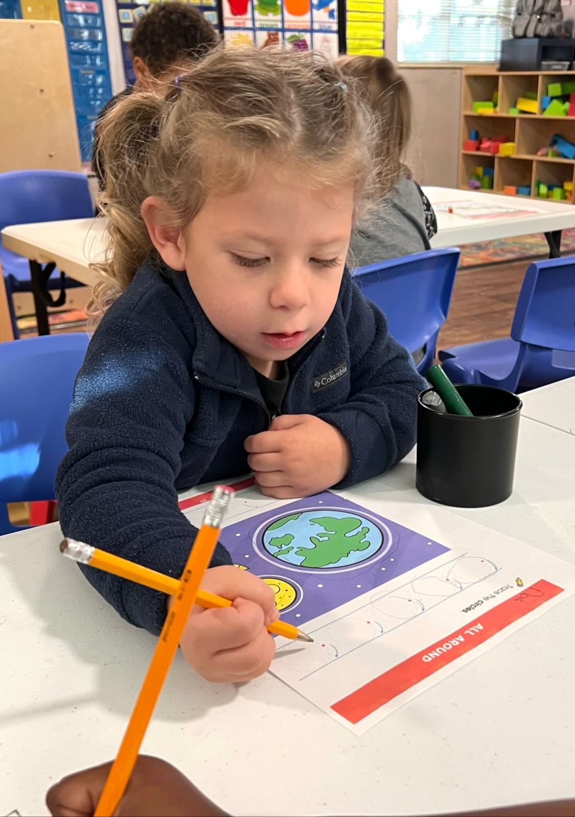 Child engaged in creative activity at Red Trolleys Daycare in Valdosta, GA, fostering growth through play.