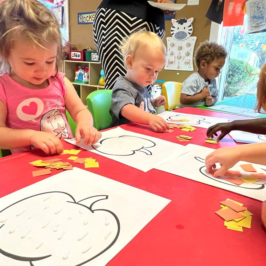 Children engaging in creative play at Red Trolleys Daycare in Valdosta, GA, with colorful activities and nurturing care.