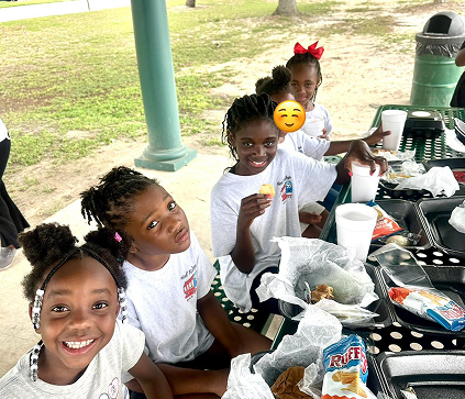 Kids enjoying a meal at Red Trolleys Daycare in Valdosta, GA.