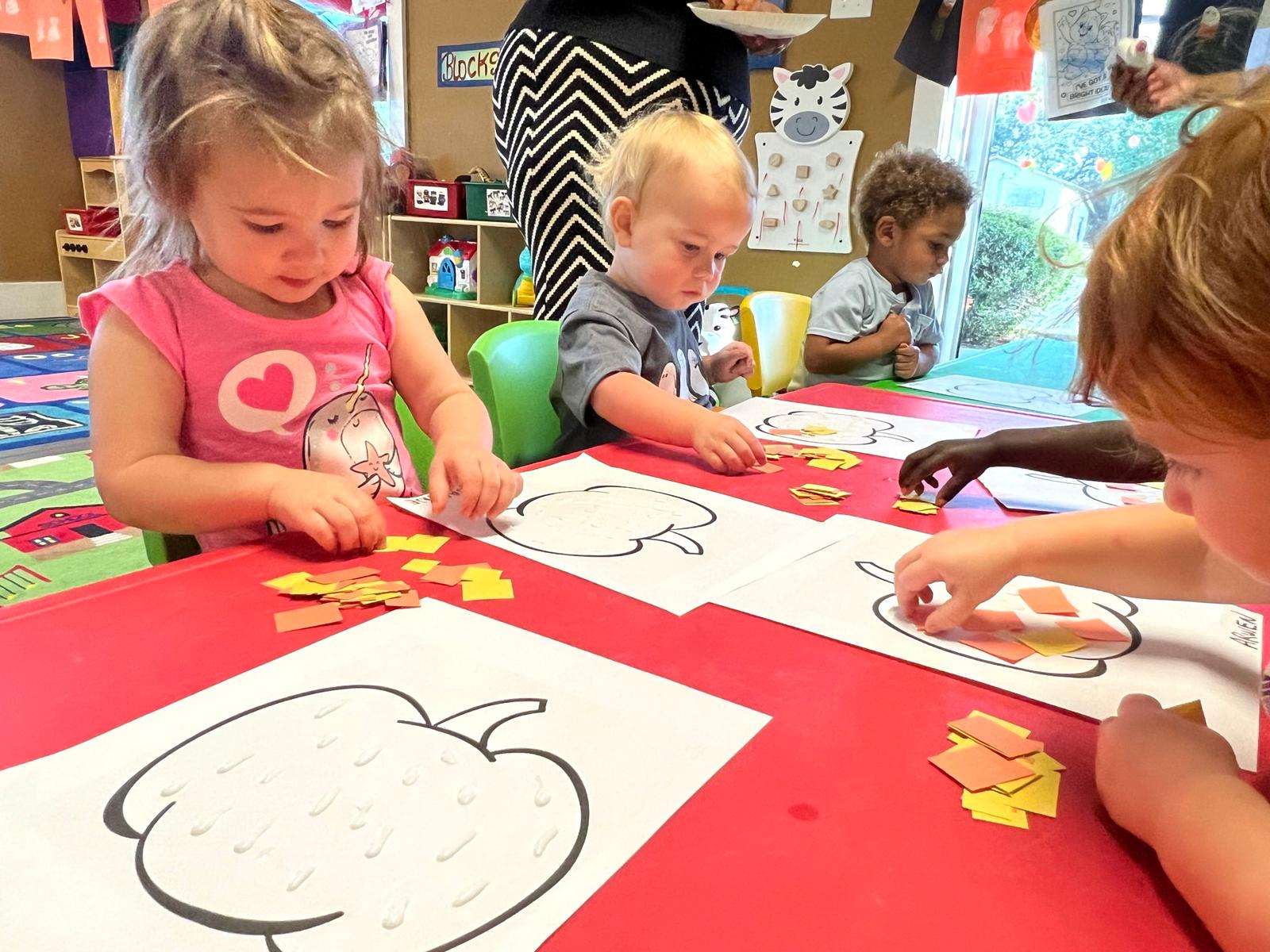 Children engaging in creative play at Red Trolleys Daycare in Valdosta, GA, with colorful activities and nurturing care.