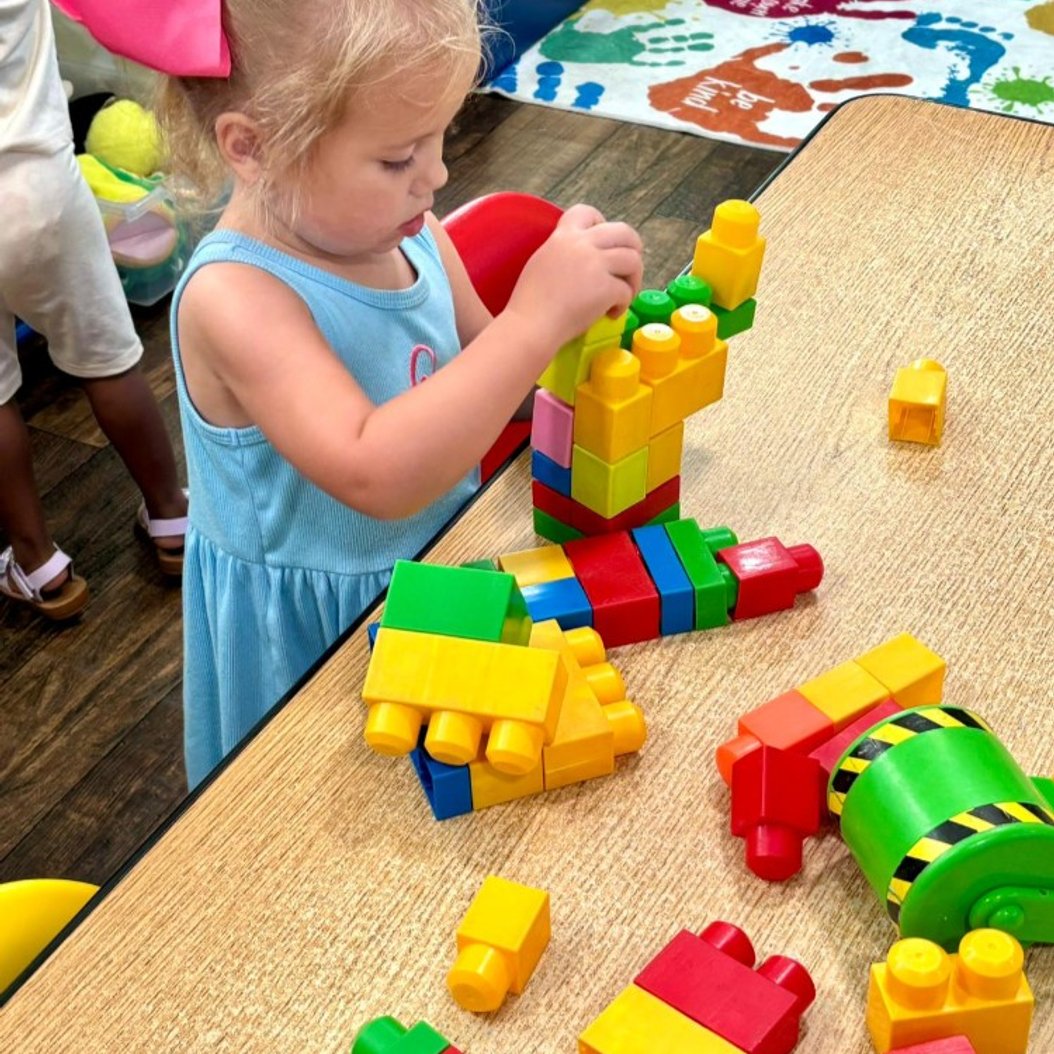 Toddler playing with colorful blocks at Active Xplorers daycare in Valdosta, GA, fostering learning and growth.