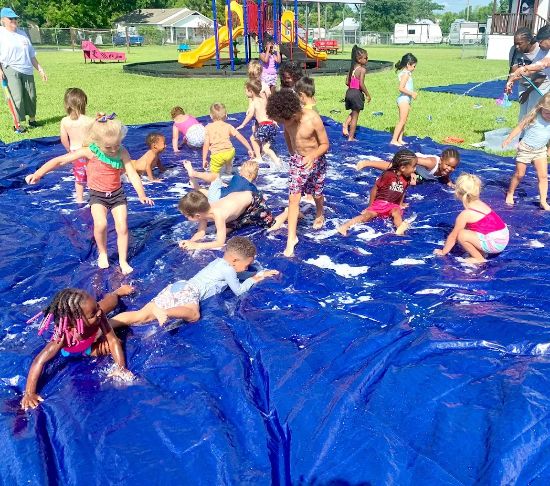 Preschool children playing outside at Red Trolleys Daycare in Valdosta, GA.