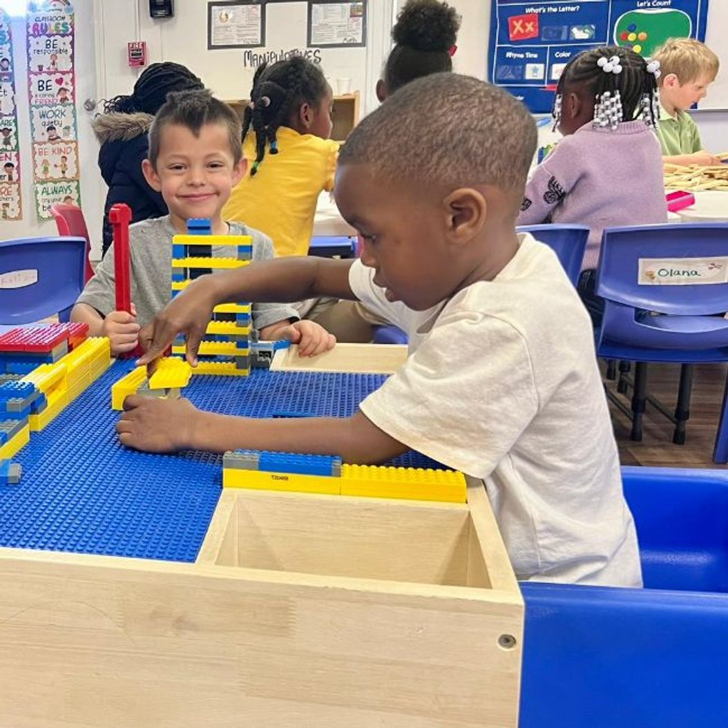 Children playing with blocks at Red Trolleys Daycare in Valdosta, GA, enjoying nurturing childcare and preschool programs.