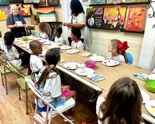 Children participating in an art activity at Red Trolleys Daycare in Valdosta, GA.