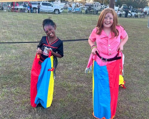 Children enjoying a sack race at a Red Trolleys Daycare family event in Valdosta, GA.