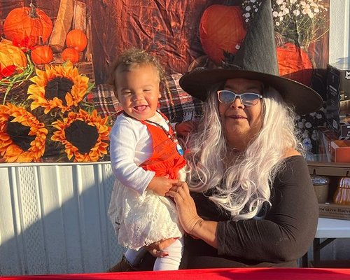 Happy baby with a caregiver at the Red Trolleys Daycare fall festival in Valdosta, GA.