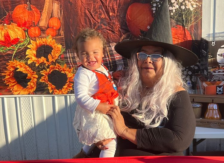 Happy baby with a caregiver at the Red Trolleys Daycare fall festival in Valdosta, GA.