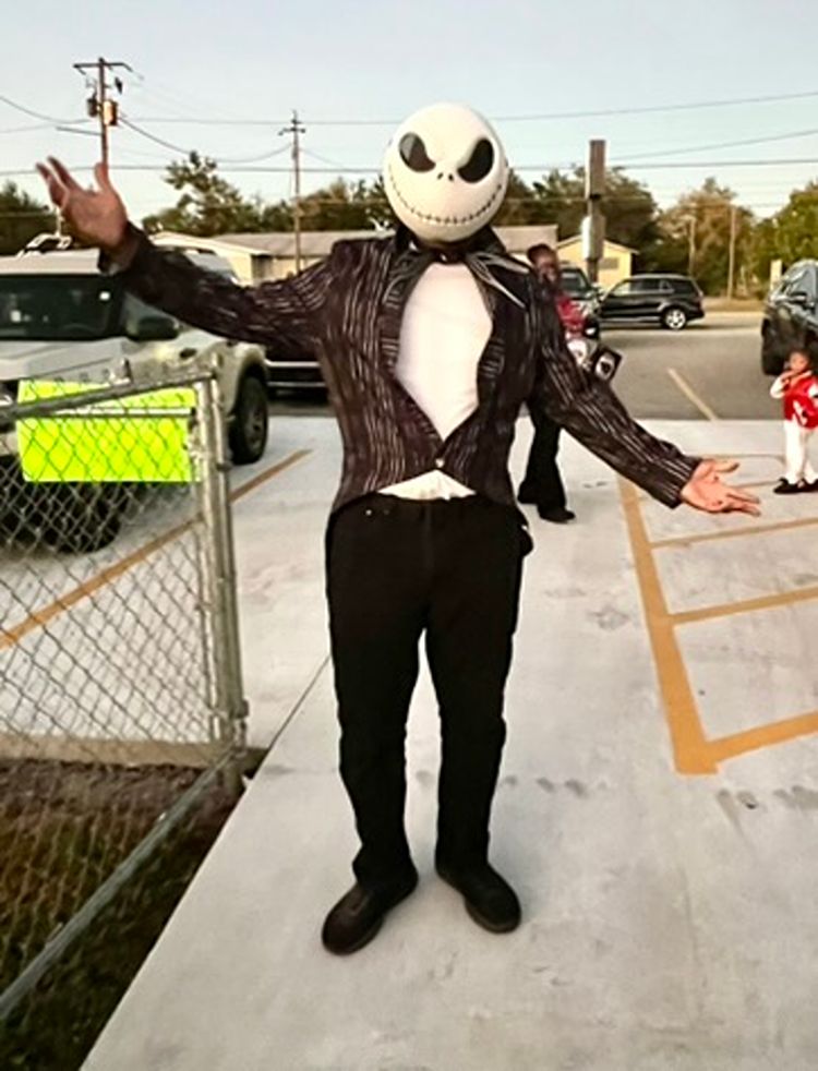 Costumed character greeting families at a Red Trolleys Daycare celebration in Valdosta, GA.