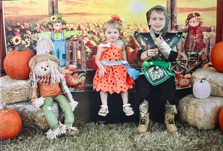 Children posing with fall decorations at the Red Trolleys Daycare pumpkin patch photo booth in Valdosta, GA.