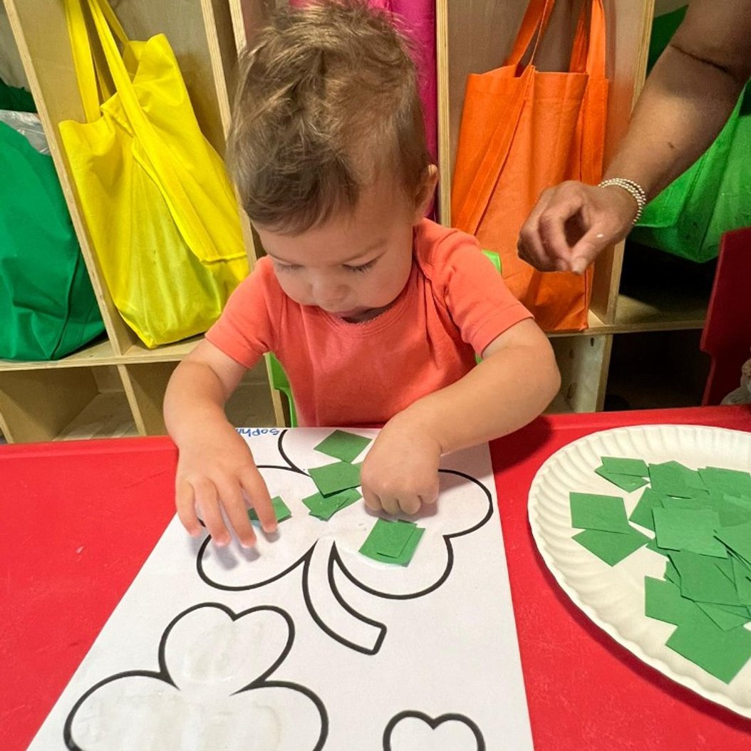 Infant engaged in early learning activity at a nurturing care center in Valdosta, GA.