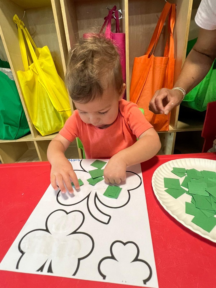 Infant engaged in early learning activity at a nurturing care center in Valdosta, GA.